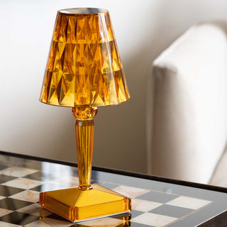 image of an amber yellow jewelled portable table lamp on a checkered side table