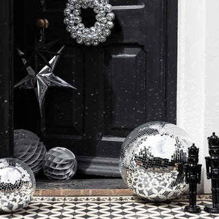 image of a front door dressed for Christmas parties with disco balls and paper decorations