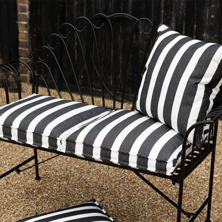 image of black & white stripe outdoor cushions on a black bench