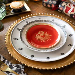 A matching plate and bowl styled with some cutlery and other dining accessories.