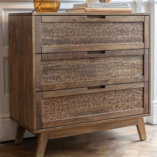 Beautiful leopard print chest of drawers in a living room set up.