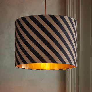 Lifestyle image of the Stripe Light Shade in front of a neutral wall.