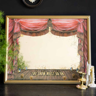 A decorative mirror with the text 'Open For Business' on in black and gold lettering, styled leaning against the wall on a wooden beam, next to a candlestick holder.