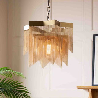 A pink glass chandelier styled in front of a black background.