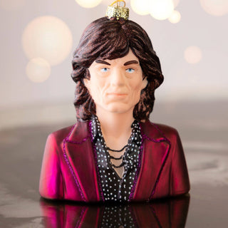 Taylor swift inspired christmas decoration laid flat on a white surface. Taylor is playing the guitar.