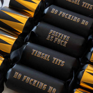 Image of a set of six black and gold embossed christmas crackers.