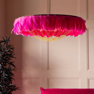 A gold cherub ceiling light styled above some accessories.