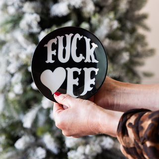 Black wooden fan leaning against a checkered mirror