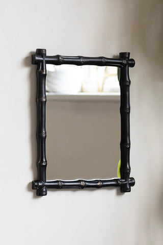 The Black Bamboo Effect Framed wall Mirror displayed on a neutral wall.