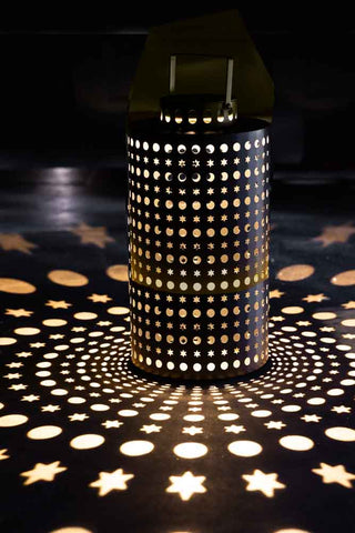 The Black Star Solar Light displayed illuminated, casting light patterns onto the floor.