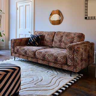 leopard print sofa in a neutral living space.