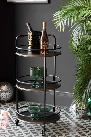 A styled image of the Antiqued-Style 3 Tier Metal Drinks Trolley.