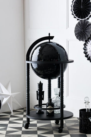 Lifestyle image of the All-Black Disco Ball Drinks Trolley Cart with party decorations. 