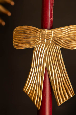Close-up image of the Antique Gold Bow Candle Pin