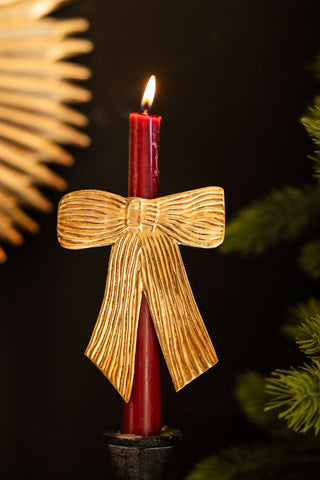 Lifestyle image of the Antique Gold Bow Candle Pin