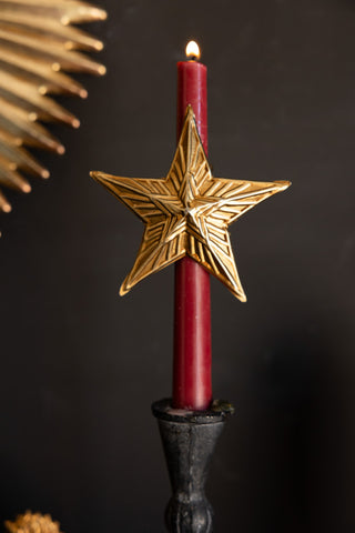 Lifestyle image of the Antique Gold Star Candle Pin