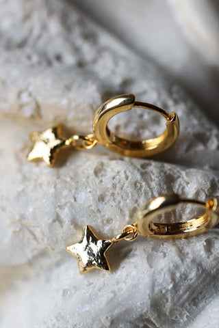 Detail image of the You're A Star Gold Huggie Hoop Earrings. 