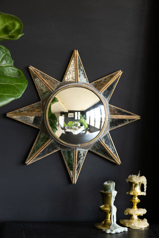 Lifestyle image of the Antiqued-Gold Sun Convex Wall Mirror