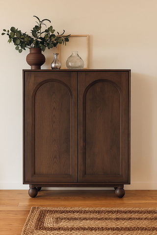 Lifestyle image of the Arc Detail 2-Door Mango Wood Cabinet