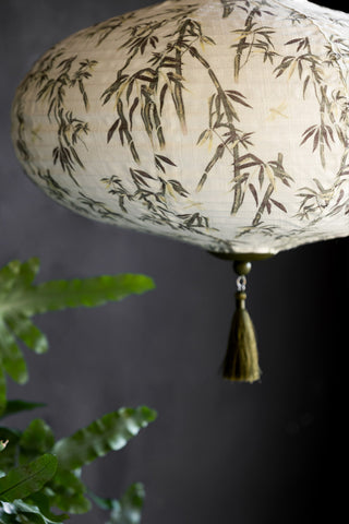 Close-up of a ceiling light shade with a bamboo pattern on it.