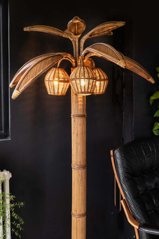 Lifestyle image of the Beautiful Rattan Palm Tree Floor Lamp.