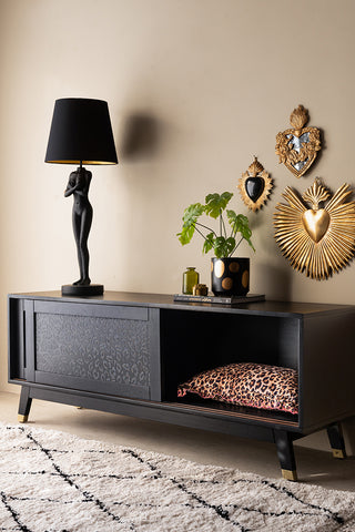 The Black Leopard Print TV Unit styled with the door open, with various accessories inside/on top.