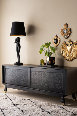 The Black Leopard Print TV Unit styled with a plant and various accessories on.