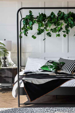 Lifestyle image of the Black Metal Four-Poster Bed - European King Size