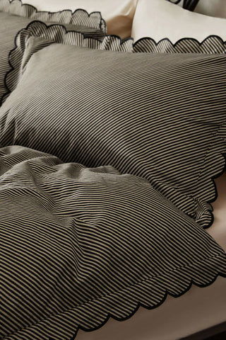 A close up of the Black Pencil Stripe Scalloped Edge Bedding Set.