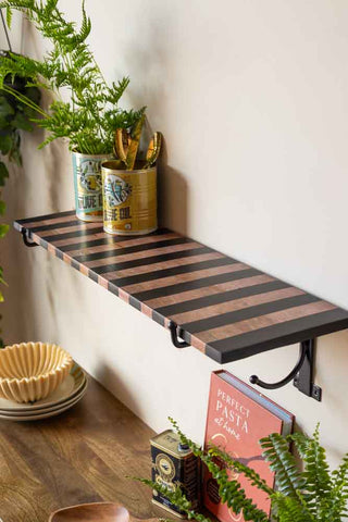 The Black Stripe Wooden Shelf With Bracket styled with various kitchen accessories and greenery.