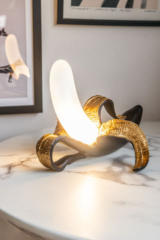 Lifestyle image of the Black & Gold Banana Table Lamp