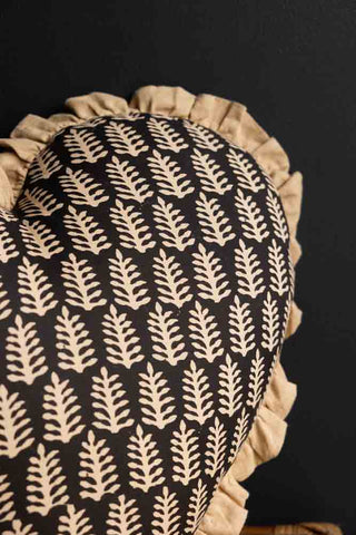Close-up image of the Black & Natural Leaf Ruffle Heart Cushion