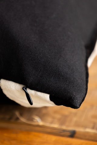 Close-up image of the reverse side and the zip of the Black & Off-White Stripe Velvet Cushion. 