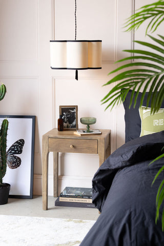 Lifestyle image of the Black & Cream Lantern Curved Ceiling Light Shade styled in blush pink bedroom.