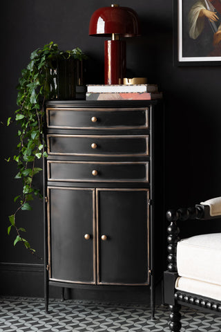 A styled image of the Black & Gold Antiqued-Style Side Cabinet.