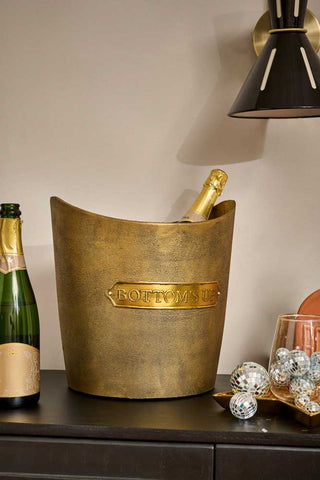 Lifestyle image of the Bottoms Up Champagne Bucket with a bottle of champagne inside.