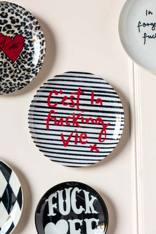 Image of the C'est La Fucking Vie Decorative Wall Plate on a wall