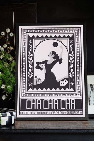Styled image of the Cha Cha A2 Art Print in Black in a black frame on a dark background