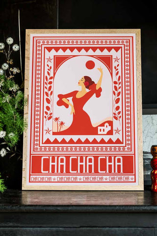Styled image of the Cha Cha A2 Art Print in Red in a natural frame on a dark background