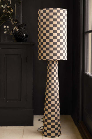 Image of the Charcoal & Natural Checkerboard Floor Lamp in a dark room next to a window.