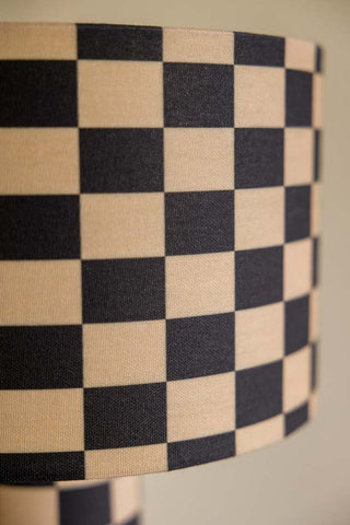 Close-up image of the Charcoal & Natural Checkerboard Table Lamp shade against a pale background