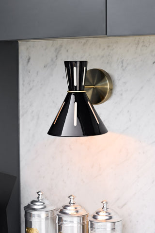 Lifestyle image of the Tribeca Metal Wall Light illuminated and displayed on a kitchen wall