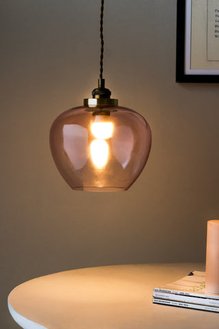 Lifestyle image of the Easyfit Pink Glass Ceiling Light Shade with bulb switched