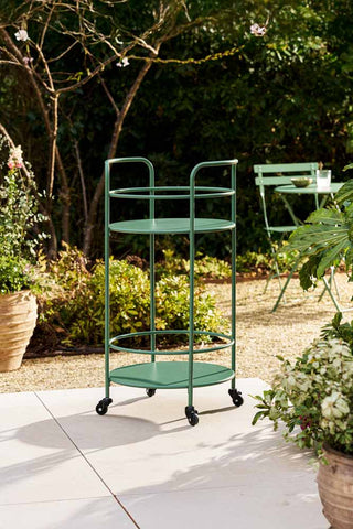 The Effortless Outdoor Drinks Trolley in Slate Green styled on a patio in the sunshine.