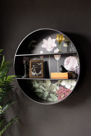 The Floral & Black Metal Display Shelves displayed on a black wall with various home accessories on, with a plant also in the shot.