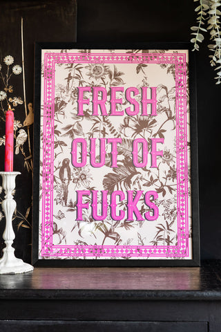 Lifestyle image of the Fresh Outta Fucks A2 Art Print in a black frame on a dark background