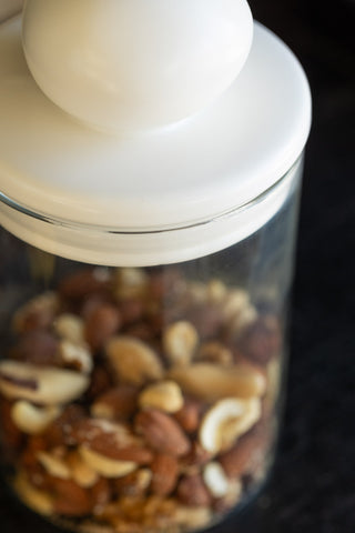 Close-up image of the Glass Storage Jar With White Ceramic Lid - Small
