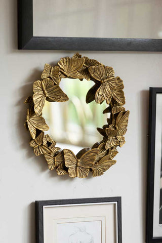Lifestyle image of the Gold Butterfly decorative Mirror.
