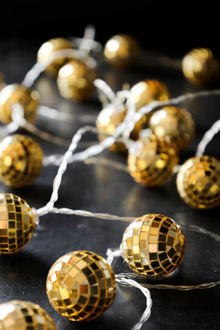 Image of the Gold Disco Ball Fairy Lights styled on a sideboard