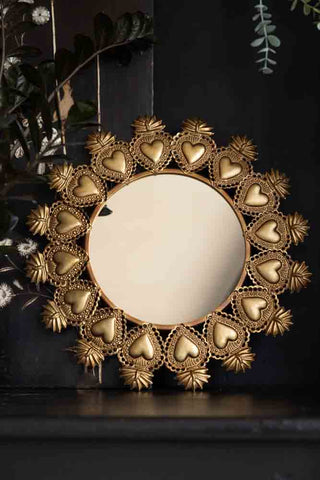 Lifestyle image of the Gold Milagro Heart decorative Mirror.